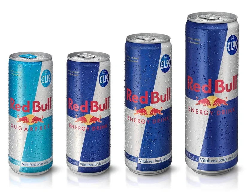 Red Bull energy drinks in various can sizes with price labels.