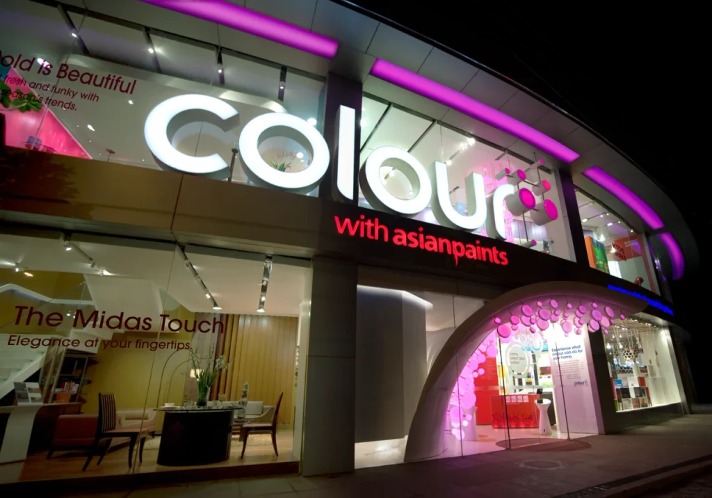 Asian Paints Colour Store exterior at night, vibrant lighting.