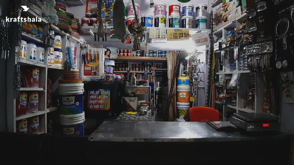 Kraftshala: Paint shop interior with colorful cans and supplies.