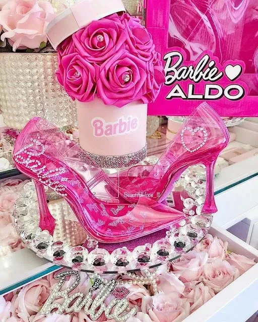 Barbie ALDO pink heels with roses and branding display.