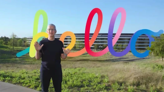 Apple CEO at Spring Loaded event with colorful &quot;hello&quot; text.